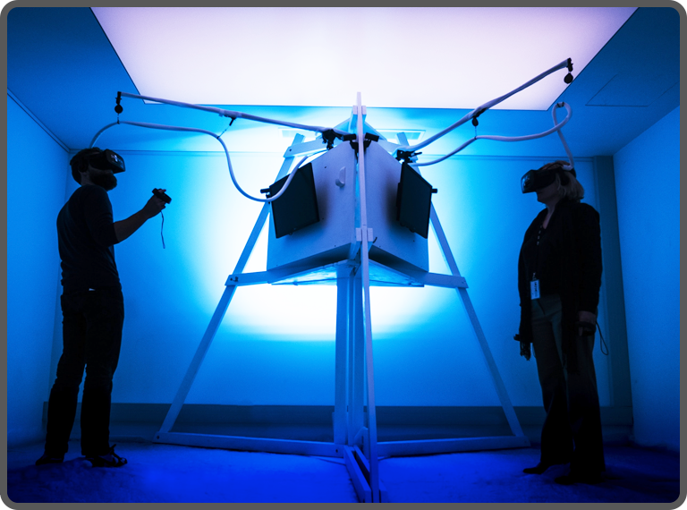 Two gamers playing VR game in a room with blue light